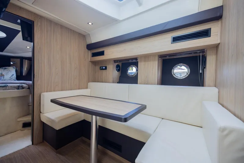 She's Royal Yacht Photos Pics Luxurious interior of 2014 Cranchi M 44 HT yacht with elegant seating and porthole windows.