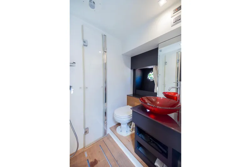 She's Royal Yacht Photos Pics Luxurious bathroom in 2014 Cranchi M 44 HT yacht with modern fixtures and red glass sink.