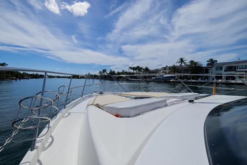 She's Royal Yacht Photos Pics 2014 Cranchi M 44 HT yacht on serene water with blue sky and waterfront homes.