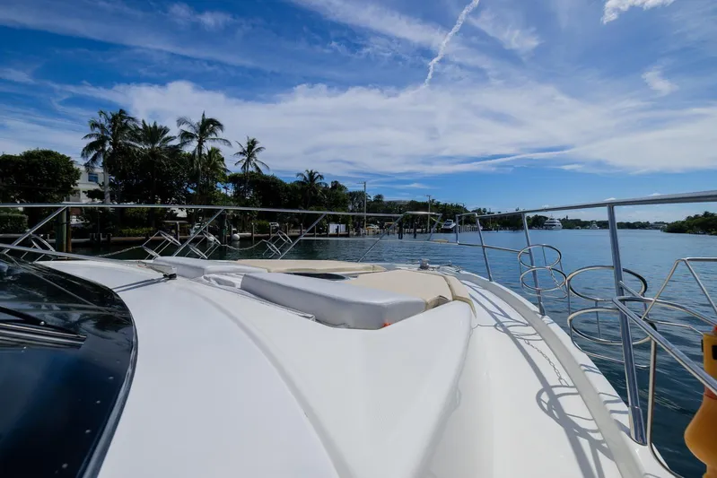 She's Royal Yacht Photos Pics 2014 Cranchi M 44 HT yacht on serene water with palm trees and blue sky.