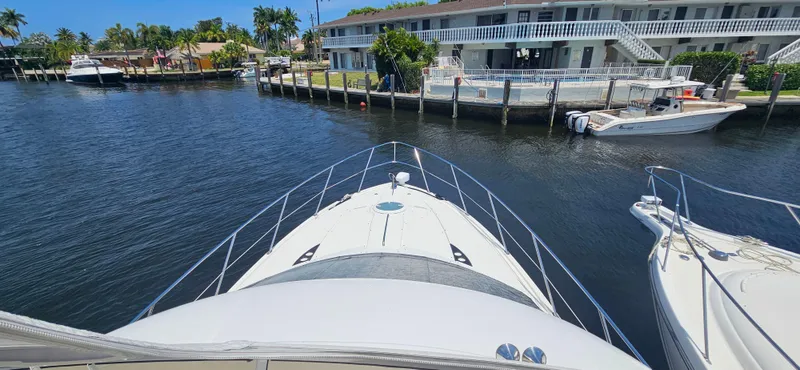 Yacht Photos Pics Bow view of 2013 Meridian 391 Sedan yacht docked near waterfront homes.