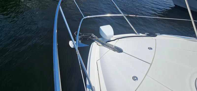  Yacht Photos Pics Bow of 2013 Meridian 391 Sedan yacht with anchor, on calm water.