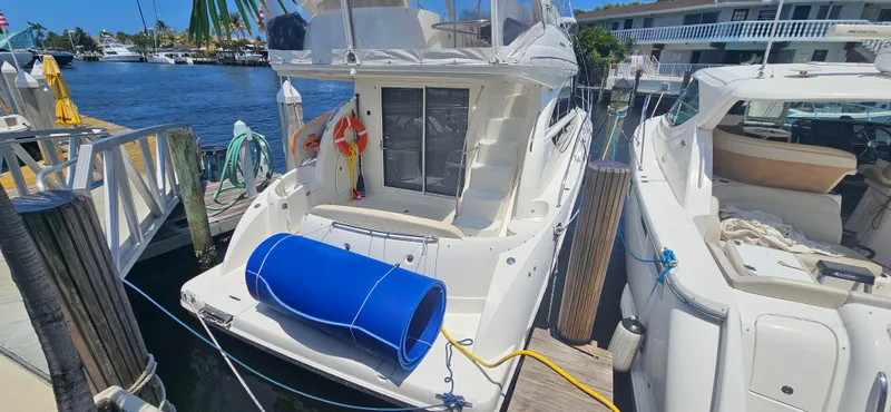  Yacht Photos Pics 2013 Meridian 391 Sedan docked, featuring a blue fender and life preserver.