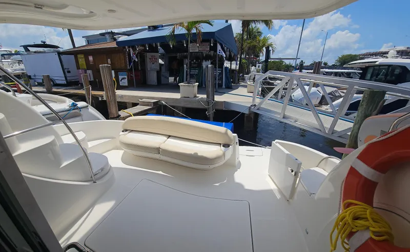  Yacht Photos Pics 2013 Meridian 391 Sedan yacht interior with dock view, featuring seating and life preserver.