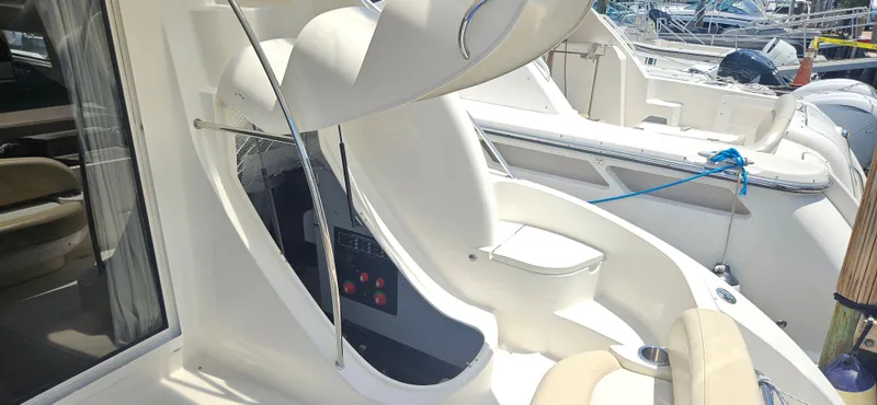  Yacht Photos Pics 2013 Meridian 391 Sedan yacht interior with seating and control panel, docked at marina.