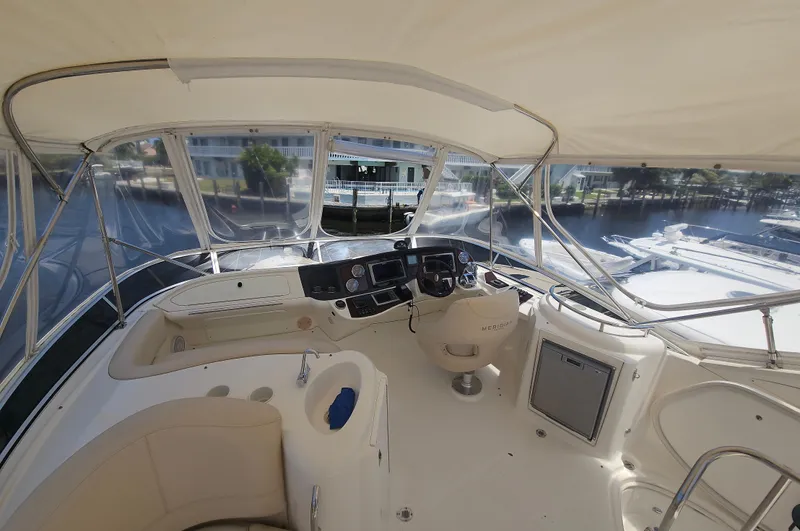  Yacht Photos Pics 2013 Meridian 391 Sedan yacht interior with helm, showcasing luxurious seating and navigation controls.