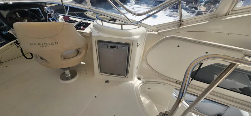 Yacht Photos Pics 2013 Meridian 391 Sedan interior with helm seat and control panel.