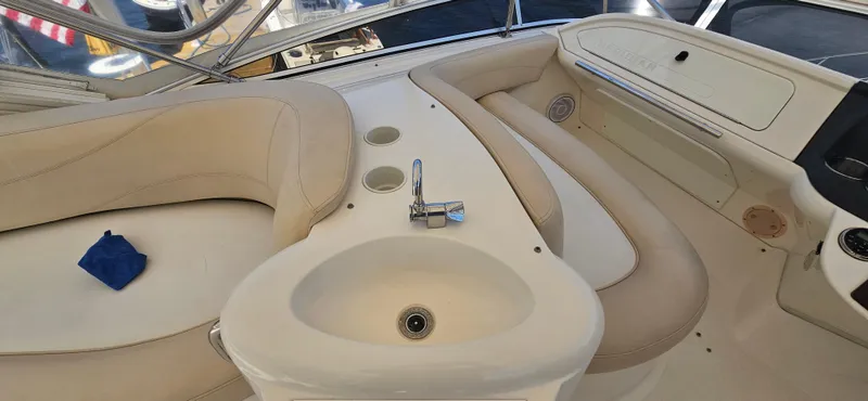  Yacht Photos Pics Interior of a 2013 Meridian 391 Sedan yacht with beige seating and a small sink.