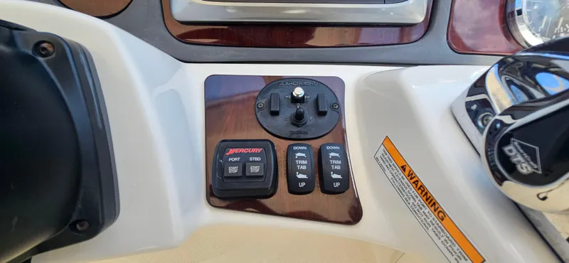  Yacht Photos Pics Control panel of a 2013 Meridian 391 Sedan boat with joystick and warning label.