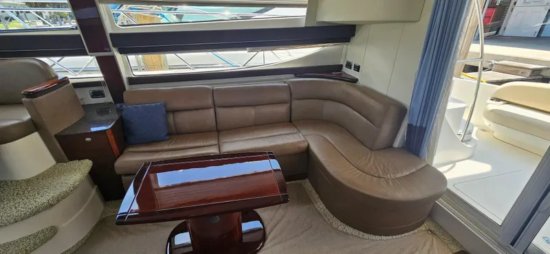  Yacht Photos Pics Luxurious interior of 2013 Meridian 391 Sedan with leather seating and wooden table.
