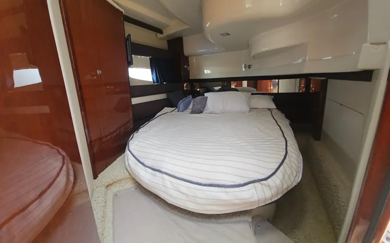  Yacht Photos Pics Luxurious bedroom interior of a 2013 Meridian 391 Sedan yacht with cozy bedding.