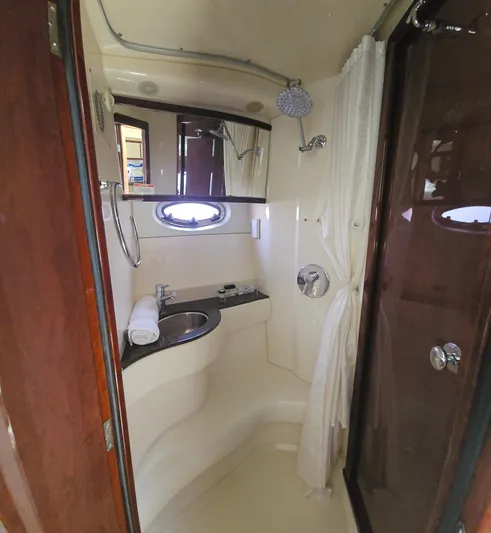  Yacht Photos Pics 2013 Meridian 391 Sedan bathroom with shower, sink, and porthole window.