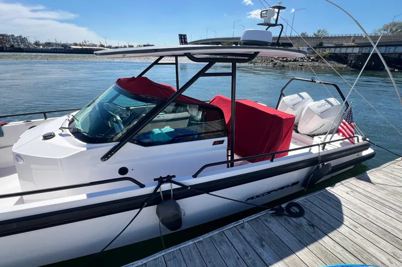  Yacht Photos Pics 2021 Axopar 28 boat docked, featuring red covers and twin engines.