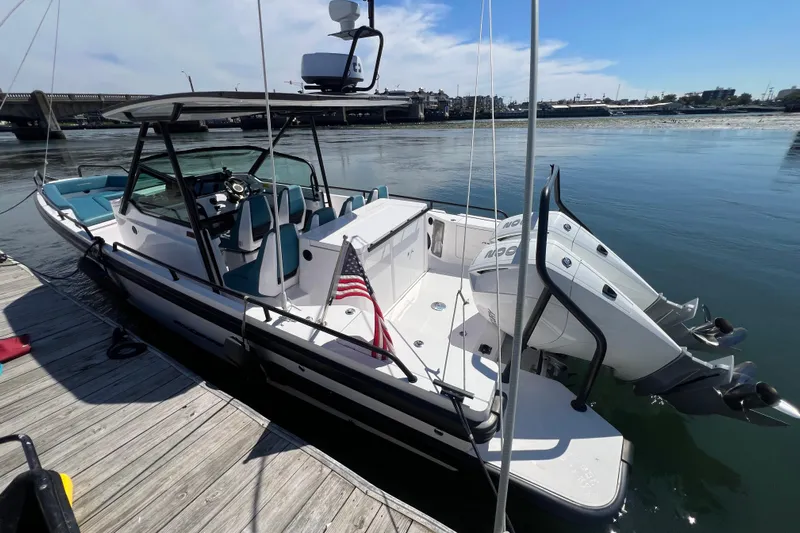  Yacht Photos Pics 2021 Axopar 28 boat docked, featuring dual engines and sleek design.