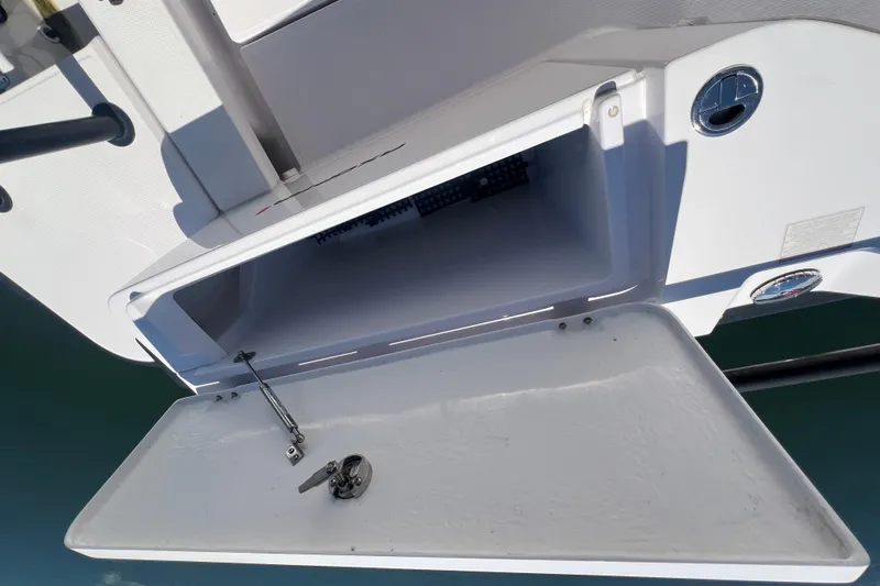  Yacht Photos Pics Open storage compartment on a 2021 Axopar 28 boat, showing interior details.