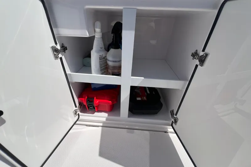  Yacht Photos Pics Open storage cabinet on 2021 Axopar 28 boat with cleaning supplies and tools.