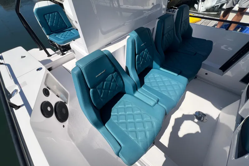  Yacht Photos Pics 2021 Axopar 28 boat interior with teal diamond-stitched seats and modern design.