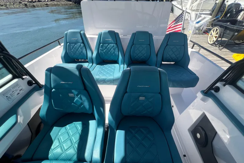  Yacht Photos Pics 2021 Axopar 28 boat interior with blue quilted seats and American flag.