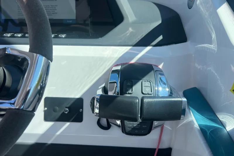  Yacht Photos Pics Close-up of 2021 Axopar 28 boat throttle controls and steering wheel.