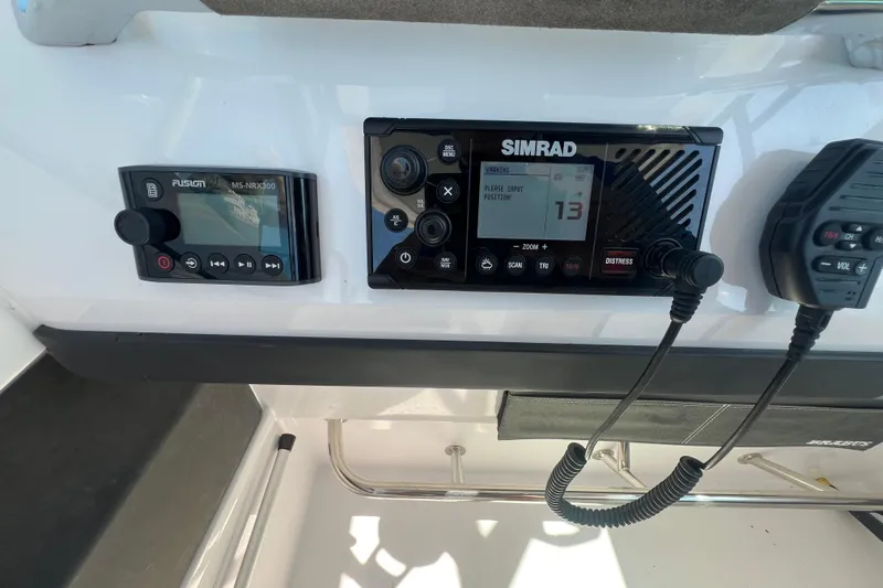  Yacht Photos Pics Control panel of a 2021 Axopar 28 boat featuring Simrad and Fusion devices.