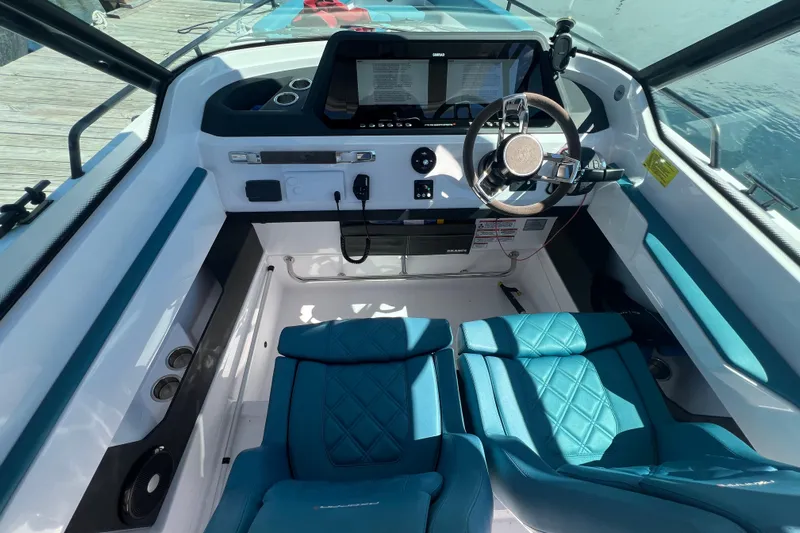  Yacht Photos Pics 2021 Axopar 28 boat interior with modern dashboard and blue seating.