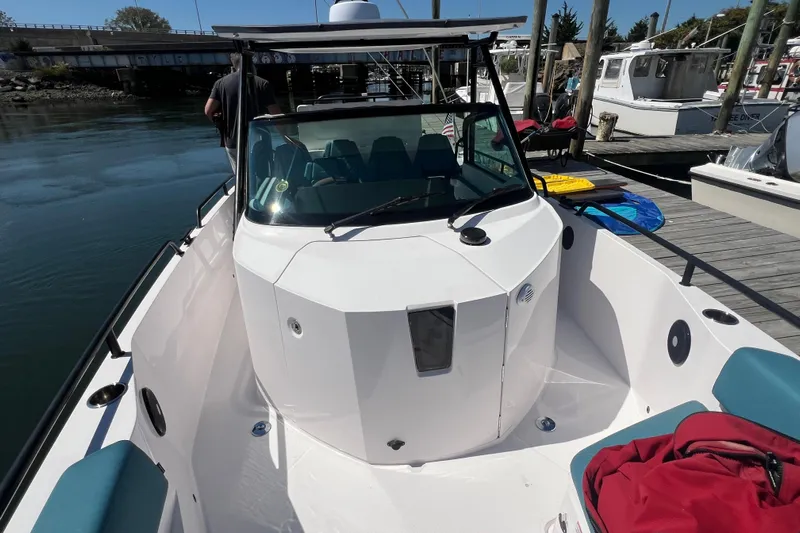  Yacht Photos Pics 2021 Axopar 28 boat docked, featuring sleek design and spacious deck area.