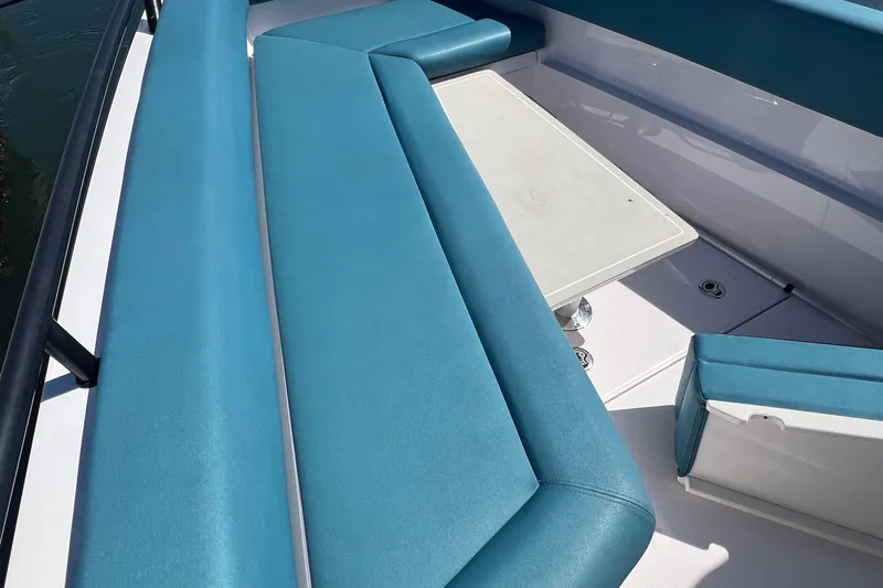  Yacht Photos Pics 2021 Axopar 28 boat with blue seating and a white table.