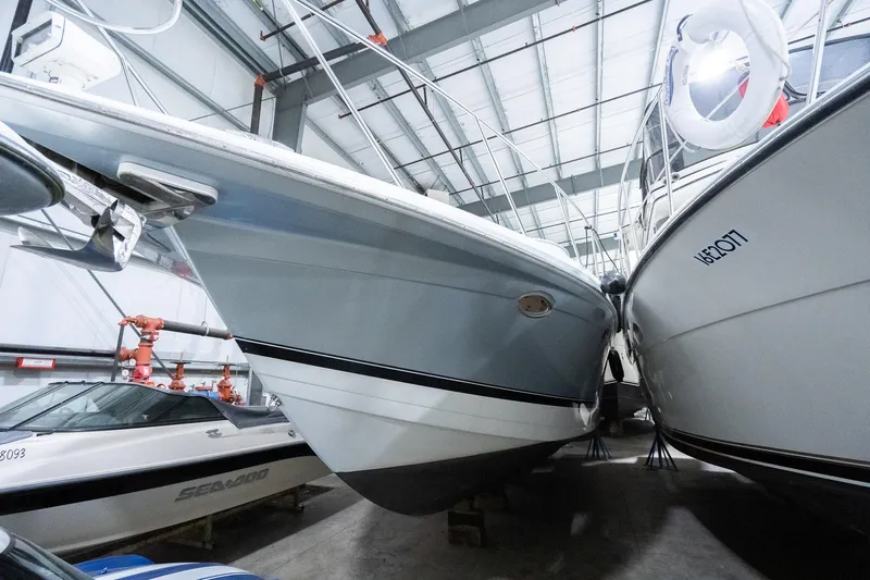 This Is Dope Yacht Photos Pics 2005 Formula 40 Cruiser in storage, surrounded by other boats in a marina facility.
