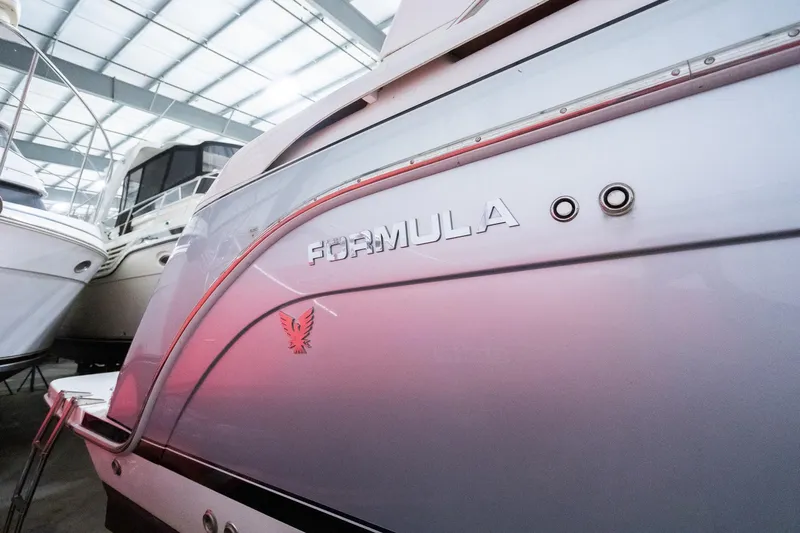 This Is Dope Yacht Photos Pics 2005 Formula 40 Cruiser boat in a marina, showcasing sleek design and branding.