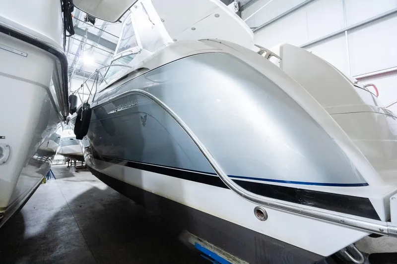 This Is Dope Yacht Photos Pics 2005 Formula 40 Cruiser yacht in storage, showcasing sleek silver hull design.