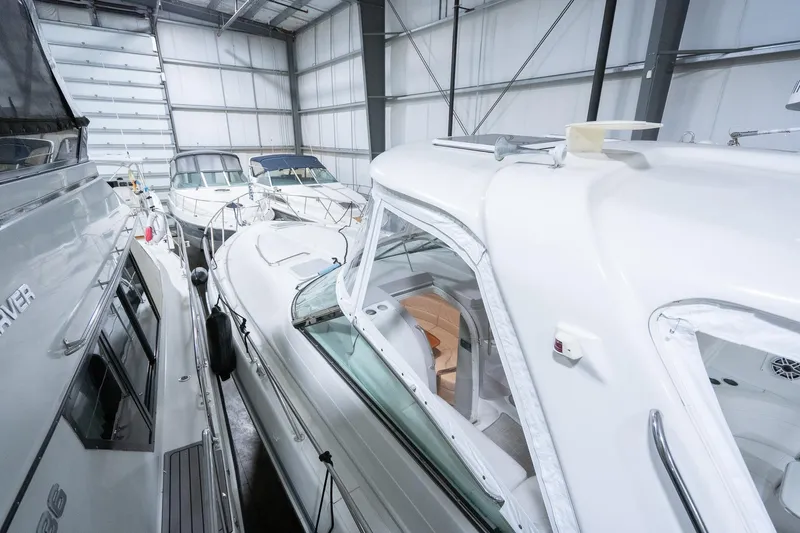 This Is Dope Yacht Photos Pics 2005 Formula 40 Cruiser in storage, surrounded by other boats in a spacious indoor facility.
