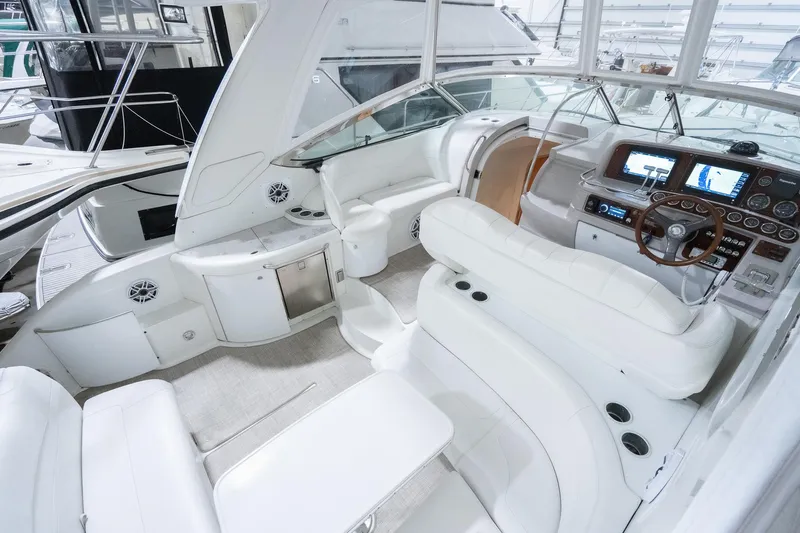 This Is Dope Yacht Photos Pics 2005 Formula 40 Cruiser yacht interior with white seating, modern dashboard, and navigation equipment.