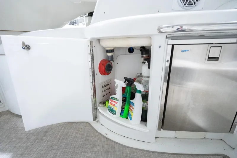 This Is Dope Yacht Photos Pics Open storage compartment on 2005 Formula 40 Cruiser with cleaning supplies and equipment.