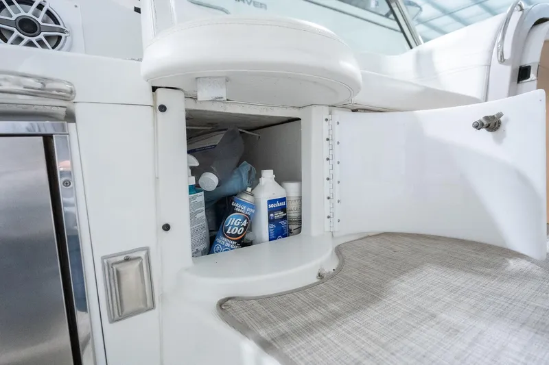 This Is Dope Yacht Photos Pics Open storage compartment on 2005 Formula 40 Cruiser with cleaning supplies inside.