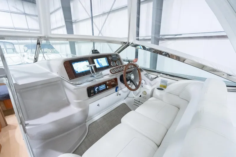 This Is Dope Yacht Photos Pics 2005 Formula 40 Cruiser cockpit with modern navigation system and luxurious white seating.