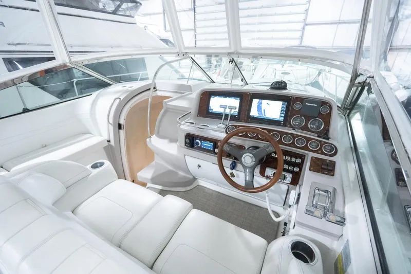 This Is Dope Yacht Photos Pics 2005 Formula 40 Cruiser cockpit with modern navigation system and luxurious white seating.