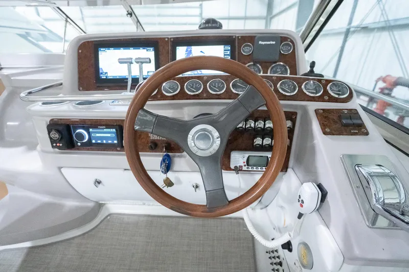 This Is Dope Yacht Photos Pics 2005 Formula 40 Cruiser helm with wood steering wheel and modern navigation instruments.