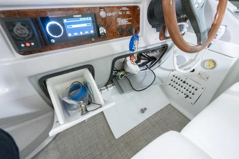 This Is Dope Yacht Photos Pics 2005 Formula 40 Cruiser helm with controls, stereo system, and storage compartments.
