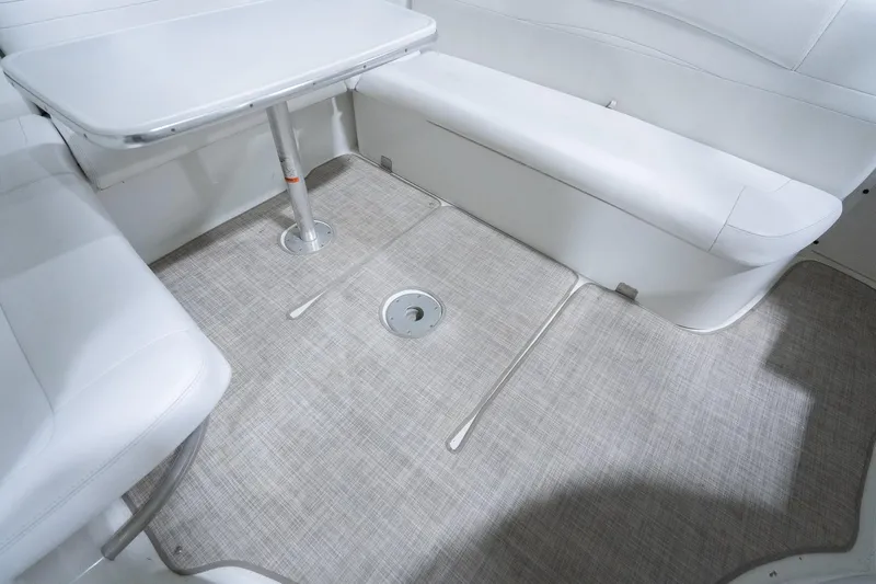 This Is Dope Yacht Photos Pics 2005 Formula 40 Cruiser interior with white seating and table, featuring a clean, carpeted floor.