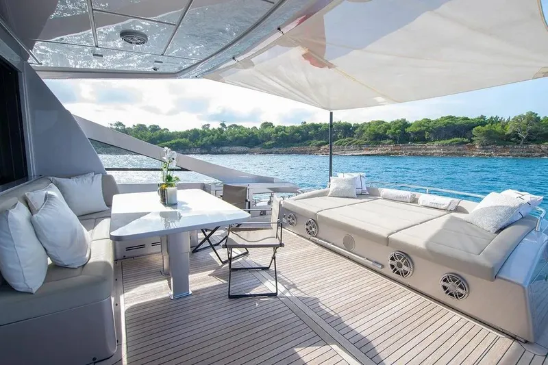  Yacht Photos Pics Luxurious 2021 Pershing 9X yacht deck with elegant seating and ocean view.