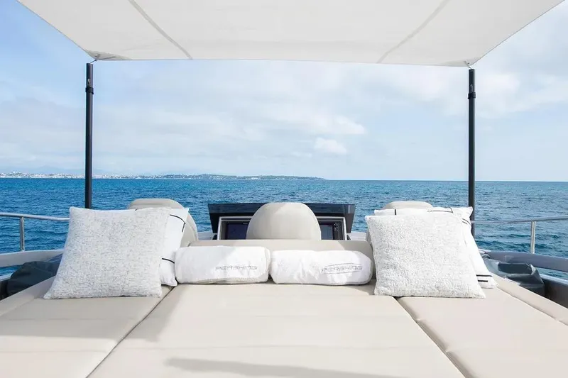  Yacht Photos Pics Luxurious 2021 Pershing 9X yacht deck with cushions, overlooking the ocean.