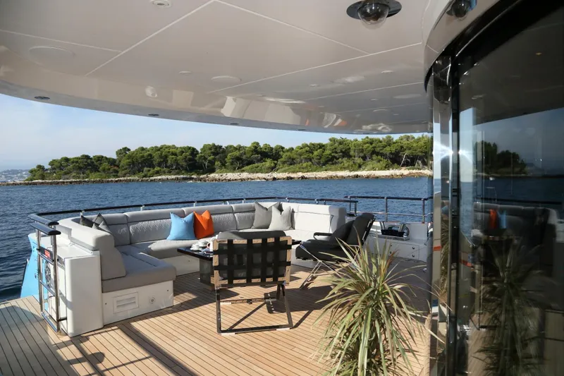 Aurelia Yacht Photos Pics Luxury Heesen 3700 yacht deck with seating area, ocean view, and lush island backdrop, 2011 model.