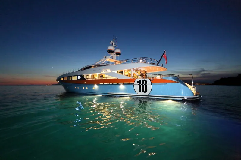 Aurelia Yacht Photos Pics Luxurious 2011 Heesen 3700 yacht illuminated at dusk on calm waters.