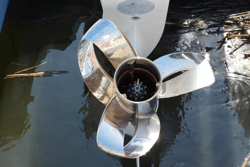  Yacht Photos Pics Shiny propeller of 2024 Pursuit DC 326 Dual Console boat in water.