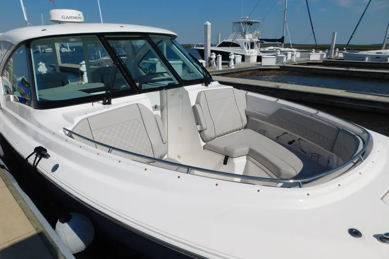  Yacht Photos Pics 2024 Pursuit DC 326 Dual Console boat docked, featuring spacious seating and sleek design.