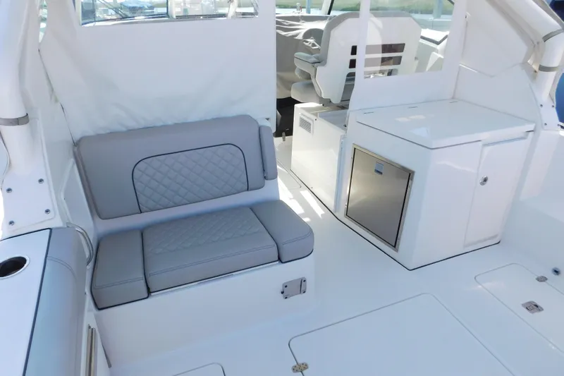  Yacht Photos Pics 2024 Pursuit DC 326 Dual Console interior with gray seating and storage compartments.