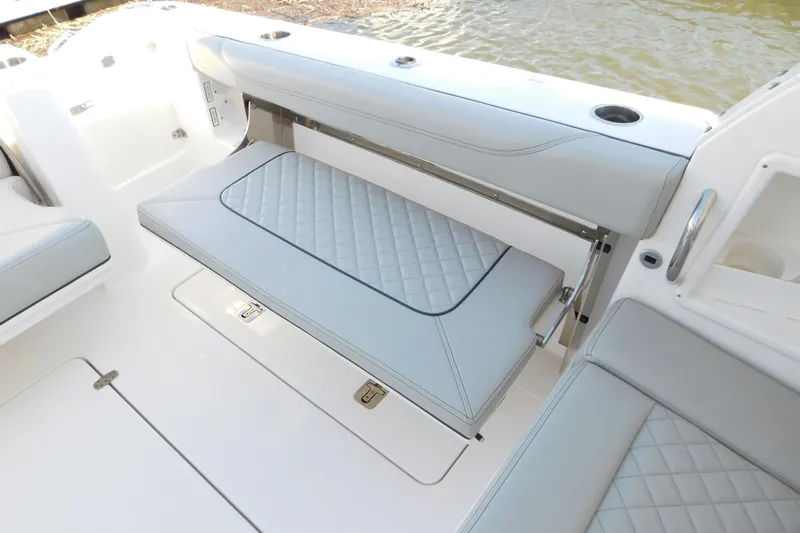  Yacht Photos Pics 2024 Pursuit DC 326 Dual Console boat interior with foldable seating and quilted upholstery.