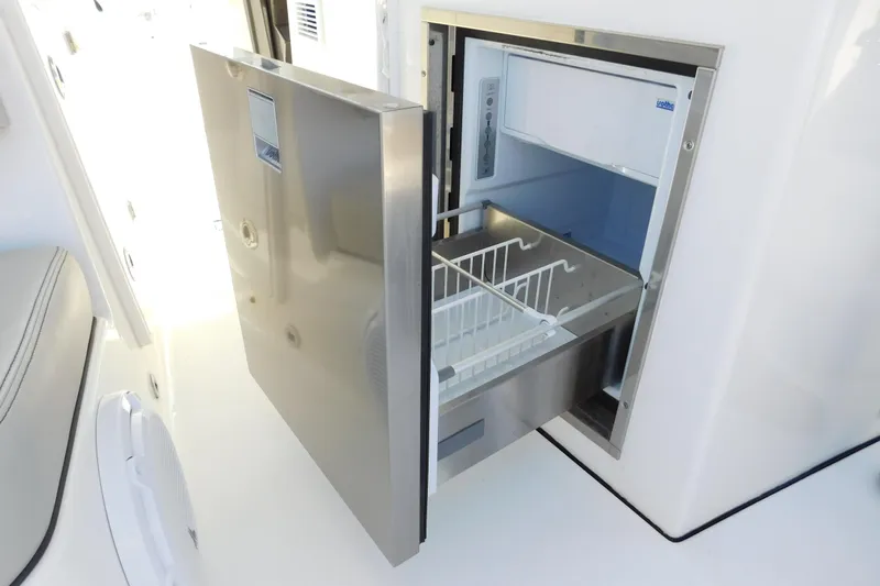  Yacht Photos Pics 2024 Pursuit DC 326 Dual Console boat with open stainless steel refrigerator drawer.