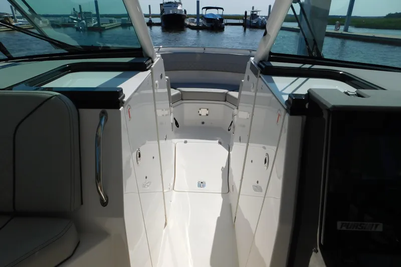  Yacht Photos Pics 2024 Pursuit DC 326 Dual Console boat interior with sleek design and waterfront view.