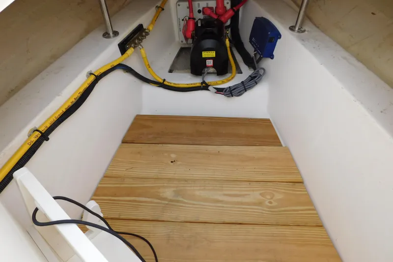  Yacht Photos Pics 2024 Pursuit DC 326 Dual Console boat interior with wooden flooring and electrical components.